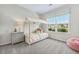 Brightly lit bedroom featuring a twin bed, a large window, and neutral decor at 99 Silver Leaf Trce, Douglasville, GA 30134