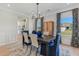 Formal dining room with wood table, stylish chairs, and decorative blue accents, adjacent to kitchen at 99 Silver Leaf Trce, Douglasville, GA 30134