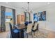 Sophisticated dining room features a modern chandelier, artwork, and elegant window treatments at 99 Silver Leaf Trce, Douglasville, GA 30134