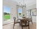 Bright breakfast nook with round table and large windows offering a view of the landscaped yard at 99 Silver Leaf Trce, Douglasville, GA 30134