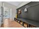 Mudroom boasts a built-in bench with storage cubbies, coat hooks, and wood flooring at 99 Silver Leaf Trce, Douglasville, GA 30134