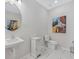 Chic powder room with a pedestal sink, marble floors, and decorative accents at 99 Silver Leaf Trce, Douglasville, GA 30134