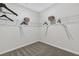 A walk-in closet featuring built-in shelving, hanging rods and carpeted floor at 99 Silver Leaf Trce, Douglasville, GA 30134