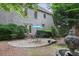 The backyard has a lovely stone patio, an umbrella, and plenty of surrounding greenery at 2250 Norbury Se Dr, Smyrna, GA 30080