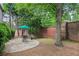 Relaxing backyard stone patio with table and chairs, perfect for outdoor dining at 2250 Norbury Se Dr, Smyrna, GA 30080