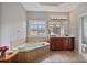 Bathroom featuring a soaking tub, a vanity with double sinks and a large window at 2250 Norbury Se Dr, Smyrna, GA 30080