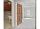 View of a carpeted bedroom with light gray walls, white trim, a tray ceiling, and an adjoining doorway at 2250 Norbury Se Dr, Smyrna, GA 30080