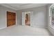 Spacious bedroom featuring neutral carpet and paint, with a doorway leading to the bathroom at 2250 Norbury Se Dr, Smyrna, GA 30080