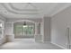 Bright, neutral bedroom featuring multiple windows, an arched entryway and white columns at 2250 Norbury Se Dr, Smyrna, GA 30080