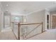 Upstairs hallway featuring decorative railing and lighting, with several rooms nearby at 2250 Norbury Se Dr, Smyrna, GA 30080