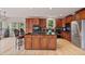 Open kitchen with stainless steel appliances, dark cabinets, and granite countertops at 2250 Norbury Se Dr, Smyrna, GA 30080