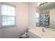 Bathroom with a window, toilet, sink, and a shower/bath with a patterned curtain at 2428 Black Forest Dr, Conyers, GA 30012