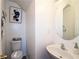 Cozy powder room with a toilet, stylish sink, and decorative artwork at 2428 Black Forest Dr, Conyers, GA 30012