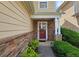 Inviting entryway featuring a stone facade and a stylish red front door at 2428 Black Forest Dr, Conyers, GA 30012