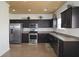 Well-equipped kitchen with stainless steel appliances and dark wood cabinetry at 2428 Black Forest Dr, Conyers, GA 30012
