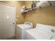 Laundry room with washer, dryer, and shelving at 2428 Black Forest Dr, Conyers, GA 30012