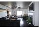 Open-concept living area featuring a fireplace, dining table, and dark wood floors at 2428 Black Forest Dr, Conyers, GA 30012