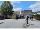 View of the neighborhood entrance gate with manicured landscaping and well-maintained townhomes at 2428 Black Forest Dr, Conyers, GA 30012