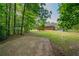 Serene backyard view with a home, sprawling lawn, and mature trees, offering a private and peaceful outdoor retreat at 299 Fieldview Dr, Auburn, GA 30011