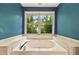 Relaxing bathroom showcases a large soaking tub with a large window at 299 Fieldview Dr, Auburn, GA 30011
