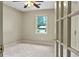 Bright bedroom featuring a ceiling fan, neutral carpet and natural light at 299 Fieldview Dr, Auburn, GA 30011