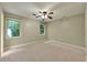 Spacious carpeted bedroom with two windows, ceiling fan and neutral tones at 299 Fieldview Dr, Auburn, GA 30011
