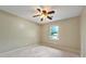 Carpeted bedroom with ceiling fan and natural light from a single window at 299 Fieldview Dr, Auburn, GA 30011