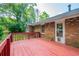 Outdoor deck with access to a brick home, offering a private and peaceful outdoor living space at 299 Fieldview Dr, Auburn, GA 30011