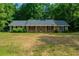 Charming one-story brick home with a well-maintained lawn and mature trees, offering a cozy and inviting curb appeal at 299 Fieldview Dr, Auburn, GA 30011