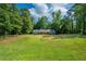 Expansive green lawn and mature trees of this one-story home offer a serene setting for comfortable living at 299 Fieldview Dr, Auburn, GA 30011