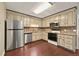 Well-lit kitchen featuring stainless steel appliances, ample cabinetry, and hardwood floors, offering a functional cooking space at 299 Fieldview Dr, Auburn, GA 30011