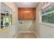 Convenient laundry room with window, cabinets and adjacent garage entrance at 299 Fieldview Dr, Auburn, GA 30011