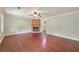 Spacious living room featuring hardwood floors, a brick fireplace, and neutral wall colors for a cozy atmosphere at 299 Fieldview Dr, Auburn, GA 30011
