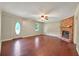 Inviting living room showcasing hardwood floors, a brick fireplace, and a classic ceiling fan, perfect for relaxation at 299 Fieldview Dr, Auburn, GA 30011