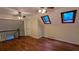 Spacious bedroom featuring hardwood floors, skylights, and ceiling fans at 3246 Able Ct, Marietta, GA 30062