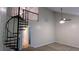 A spiral staircase leads to the loft area in this carpeted room with ceiling fan and vaulted ceilings at 3246 Able Ct, Marietta, GA 30062