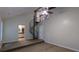 Carpeted room with vaulted ceilings, ceiling fan, spiral staircase to loft, and access to the kitchen at 3246 Able Ct, Marietta, GA 30062