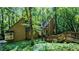 Beautiful home exterior with unique architectural design and inviting entry, surrounded by natural landscaping and tall trees at 3246 Able Ct, Marietta, GA 30062