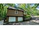 Exterior shot of a home with a two-car garage and a retaining wall, with some surrounding greenery at 3246 Able Ct, Marietta, GA 30062