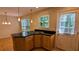 Well-lit eat-in kitchen with breakfast bar island, gas stovetop, pendant lighting, outside access door and wood floors at 3246 Able Ct, Marietta, GA 30062