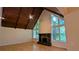Cozy living room with a stone fireplace, hardwood floors, and large windows offering scenic views at 3246 Able Ct, Marietta, GA 30062