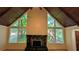 Living room featuring a fireplace, high ceilings, large windows with outside views, and hardwood floors at 3246 Able Ct, Marietta, GA 30062