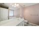 The bathroom features double sinks, granite counters, a large mirror, tile floors and modern hardware at 3971 Canebrake Ln, Douglasville, GA 30134