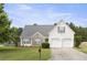 Classic two-story home with a two-car garage and beautiful front lawn, radiating suburban charm at 3971 Canebrake Ln, Douglasville, GA 30134