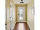 Well-lit hallway with wood flooring and a decorative front door, creating a welcoming entrance at 3971 Canebrake Ln, Douglasville, GA 30134