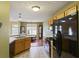 Traditional kitchen with oak cabinets and black appliances overlooking the dining area, ready for entertaining at 3971 Canebrake Ln, Douglasville, GA 30134