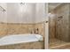 Bright bathroom with a walk-in shower, soaking tub, and neutral tile at 4108 Berryhill Se Trce, Smyrna, GA 30082