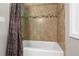 Bathroom with a bathtub featuring ceramic tile, decorative accent tiles, and shower curtain at 4108 Berryhill Se Trce, Smyrna, GA 30082