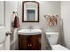 Cozy half bathroom with corner sink, a mirror, and towel rack; next to a white door at 4108 Berryhill Se Trce, Smyrna, GA 30082