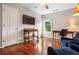 Spare bedroom area featuring hardwood floors, tv, seating, and a large window at 4108 Berryhill Se Trce, Smyrna, GA 30082